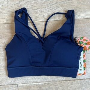 NEW WITH TAGS Navy athletic top with cute criss cross detail, bra cups, lined XS